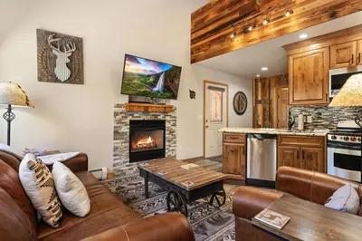 a living room with a couch and a fireplace at Creekside Suites 03 by Estes Park Condos in Estes Park