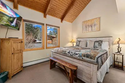 a bedroom with a bed and a window at Creekside Suites 03 by Estes Park Condos in Estes Park