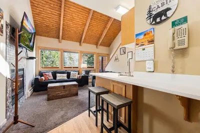 a room with a bar and a living room at Creekside Suites 04 by Estes Park Condos in Estes Park