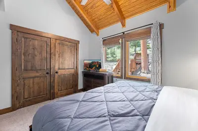 a bedroom with a large bed and a window at Creekside Suites 09 by Estes Park Condos in Estes Park