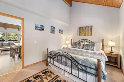 a bedroom with a bed and a dining room at Creekside Suites 20 by Estes Park Condos in Estes Park