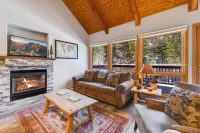 a living room with a couch and a fireplace at Creekside Suites 20 by Estes Park Condos in Estes Park