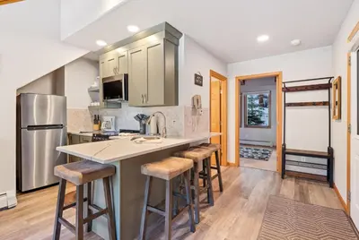 a kitchen with a large island with bar stools at Creekside Suites 20 by Estes Park Condos in Estes Park