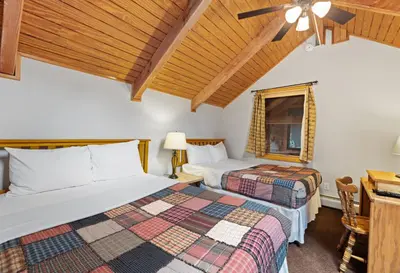 a bedroom with two beds and a ceiling fan at Creekside Suites 10 by Estes Park Condos in Estes Park