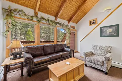 a living room with a couch and a chair at Creekside Suites 10 by Estes Park Condos in Estes Park
