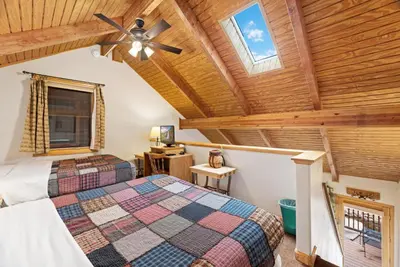 a bedroom with two beds and a ceiling fan at Creekside Suites 10 by Estes Park Condos in Estes Park
