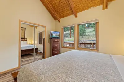 a bedroom with a bed and a large window at Creekside Suites 11 by Estes Park Condos in Estes Park