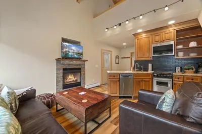 a living room with a couch and a fireplace at Creekside Suites 11 by Estes Park Condos in Estes Park