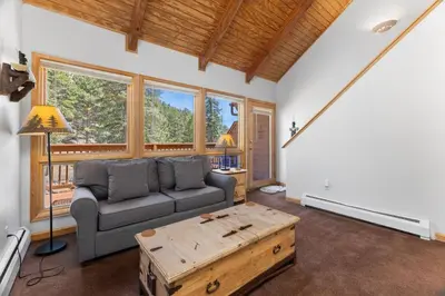 a living room with a couch and a coffee table at Creekside Suites 18 by Estes Park Condos in Estes Park