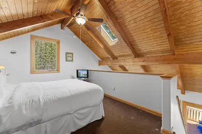 a bedroom with a bed and a ceiling fan at Creekside Suites 18 by Estes Park Condos in Estes Park