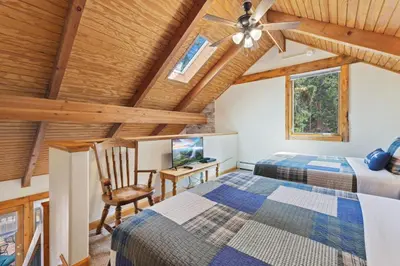 a bedroom with two beds and a ceiling fan at Creekside Suites 21 by Estes Park Condos in Estes Park
