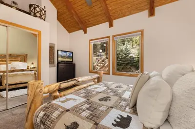a bedroom with a large bed and a window at Creekside Suites 19 by Estes Park Condos in Estes Park