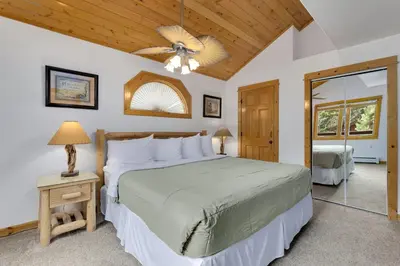 a bedroom with a bed and a ceiling fan at Bugle Pointe B23 by Estes Park Condos in Estes Park