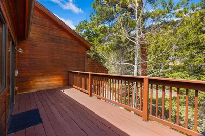 a large wooden deck on the side of a house at Bugle Pointe B23 by Estes Park Condos in Estes Park