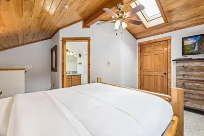 a bedroom with a bed and a ceiling fan at Bugle Pointe A01 by Estes Park Condos in Estes Park