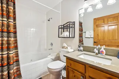 a bathroom with a tub and a toilet and a sink at Bugle Pointe A01 by Estes Park Condos in Estes Park
