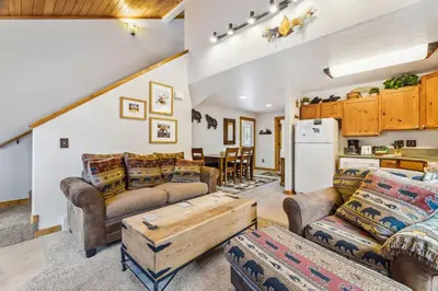a living room with couches and a table at Bugle Pointe A01 by Estes Park Condos in Estes Park