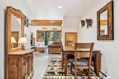 a dining room with a table and chairs at Bugle Pointe A01 by Estes Park Condos in Estes Park