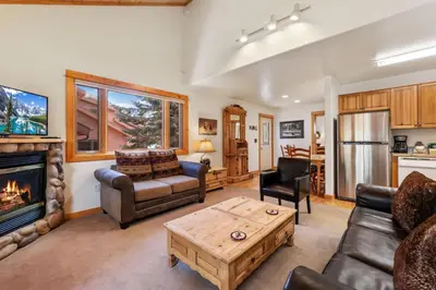 a living room with a couch and a fireplace at Bugle Pointe A08 by Estes Park Condos in Estes Park