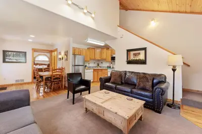 a living room with a couch and a table at Bugle Pointe A08 by Estes Park Condos in Estes Park