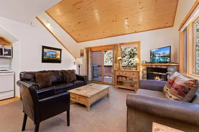 a living room with a couch and a table at Bugle Pointe A08 by Estes Park Condos in Estes Park