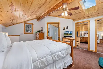 a bedroom with a bed and a ceiling fan at Bugle Pointe A10 by Estes Park Condos in Estes Park