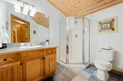 a bathroom with a shower and a toilet and a sink at Bugle Pointe A10 by Estes Park Condos in Estes Park
