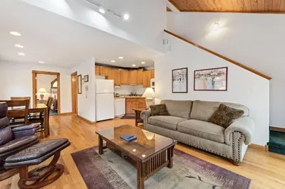 a living room with a couch and a table at Bugle Pointe A11 by Estes Park Condos in Estes Park