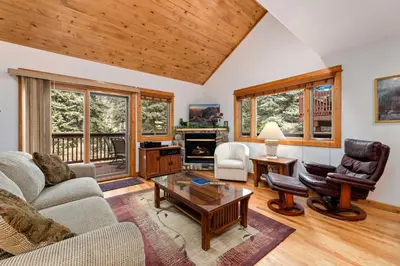 a living room with a couch and a table at Bugle Pointe A11 by Estes Park Condos in Estes Park