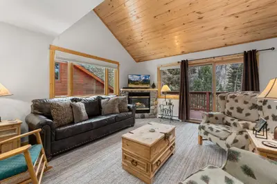 a living room with a couch and a table at Bugle Pointe A12 by Estes Park Condos in Estes Park