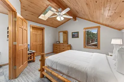 a bedroom with a bed and a ceiling fan at Bugle Pointe A12 by Estes Park Condos in Estes Park