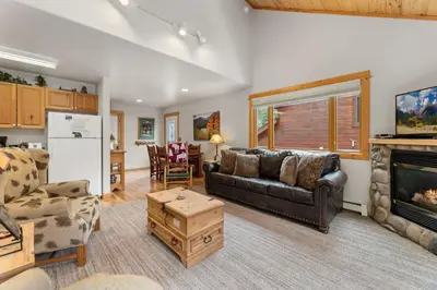 a living room with a couch and a fireplace at Bugle Pointe A12 by Estes Park Condos in Estes Park