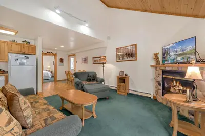 a living room with a couch and a fireplace at Bugle Pointe A14 by Estes Park Condos in Estes Park