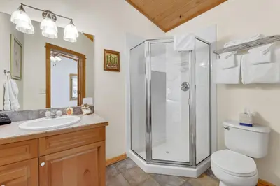 a bathroom with a shower and a toilet and a sink at Bugle Pointe A14 by Estes Park Condos in Estes Park
