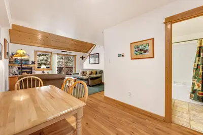 a dining room and living room with a table at Bugle Pointe A14 by Estes Park Condos in Estes Park