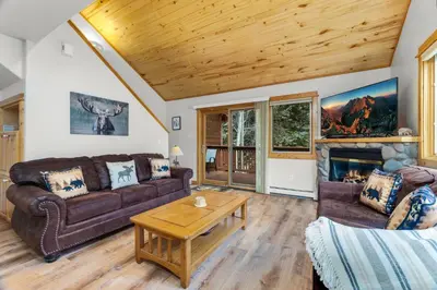 a living room with a couch and a table at Bugle Pointe A15 by Estes Park Condos in Estes Park
