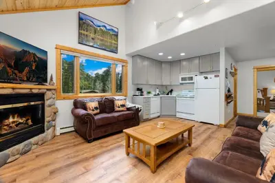 a living room with a couch and a fireplace at Bugle Pointe A15 by Estes Park Condos in Estes Park