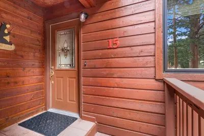 a wooden house with a door with the number on it at Bugle Pointe A15 by Estes Park Condos in Estes Park