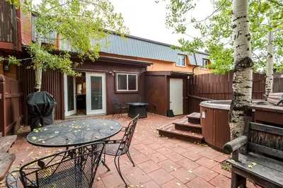 a patio with a table and chairs next to a building at Frisco 8 Townhomes #4 by Great Western Lodging in Frisco