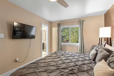 a bedroom with a bed and a flat screen tv at Frisco 8 Townhomes #4 by Great Western Lodging in Frisco
