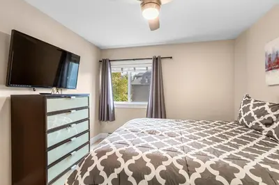 a bedroom with a bed and a flat screen tv at Frisco 8 Townhomes #4 by Great Western Lodging in Frisco