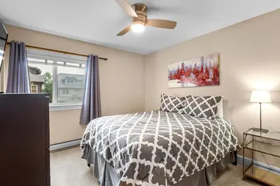 a bedroom with a bed and a ceiling fan at Frisco 8 Townhomes #4 by Great Western Lodging in Frisco