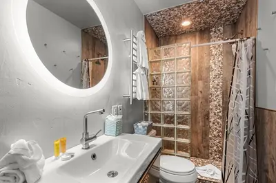 a bathroom with a sink and a toilet and a mirror at Frisco 8 Townhomes #4 by Great Western Lodging in Frisco