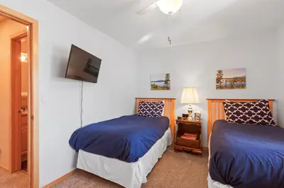 a bedroom with two beds and a tv on the wall at Lagoon 723D by Great Western Lodging in Frisco
