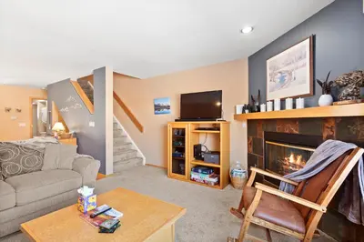 a living room with a couch and a fireplace at Lagoon 723D by Great Western Lodging in Frisco