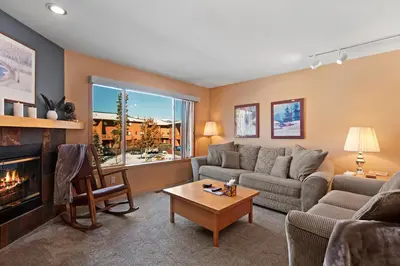 a living room with a couch and a fireplace at Lagoon 723D by Great Western Lodging in Frisco
