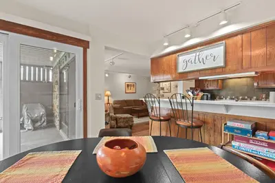 a dining room with a table with a vase on it at Lake Cliffe A101 by Great Western Lodging in Dillon