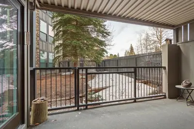 a screened in porch with a gate and a table at Lake Cliffe A101 by Great Western Lodging in Dillon