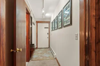 a hallway with a door and some pictures on the walls at Lake Cliffe A101 by Great Western Lodging in Dillon