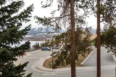 a car driving down a road with mountains in the background at Lake Cliffe E201 by Great Western Lodging in Dillon